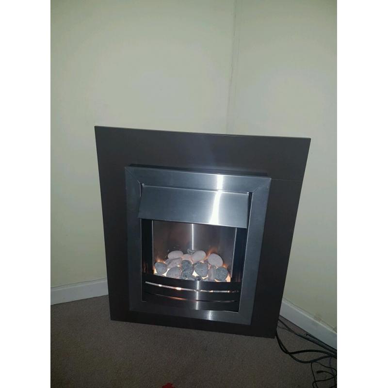 Electric fire place, brown surround and wall mountable