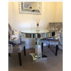 Stunning mirrored glass dining table and two mink crushed velvet door knocker chairs